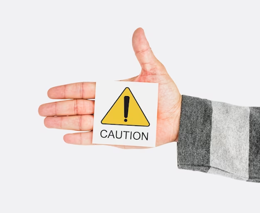 Hand with a caution symbol on a piece of paper